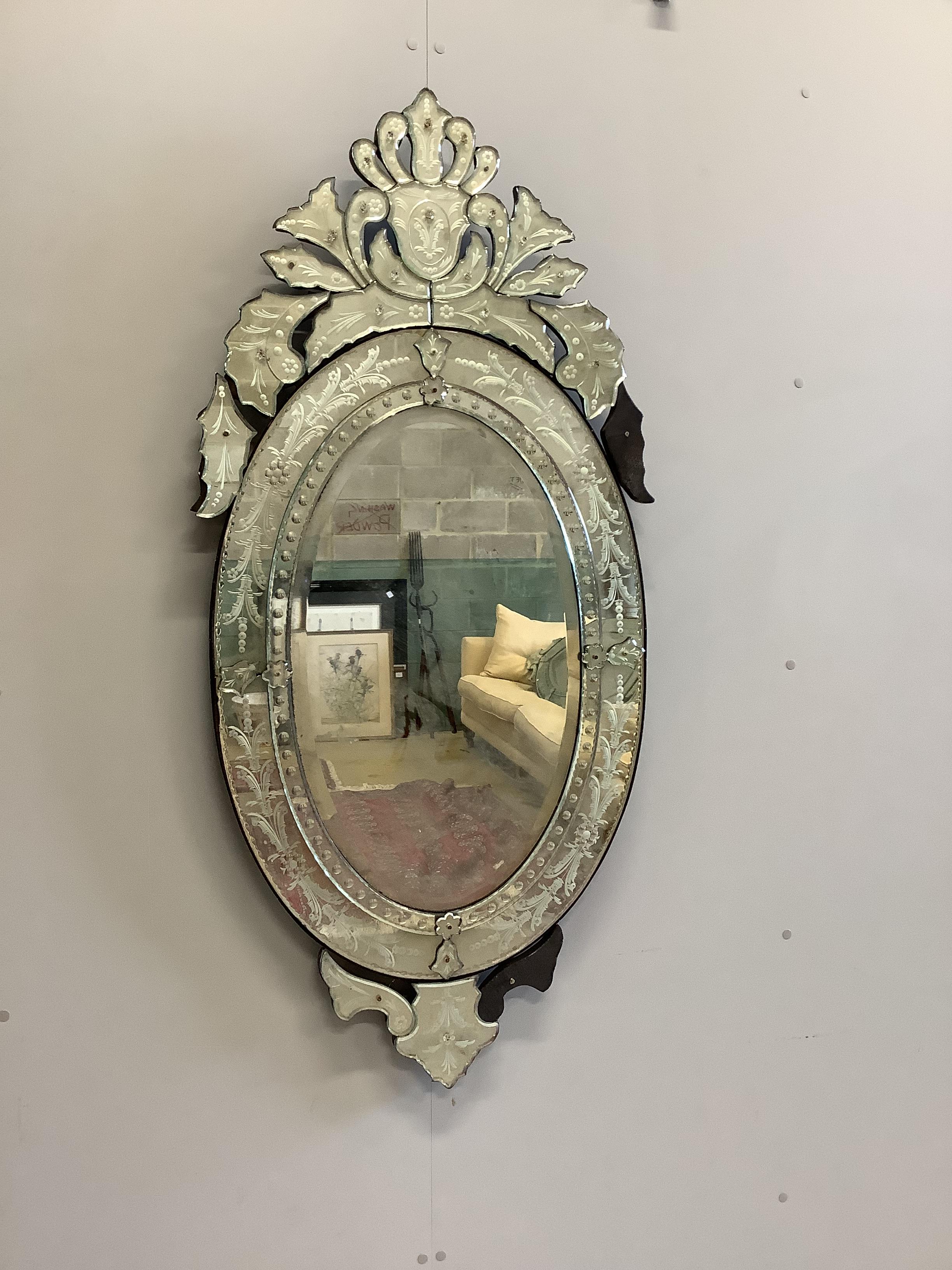 A Venetian style oval wall mirror, width 66cm, height 139cm